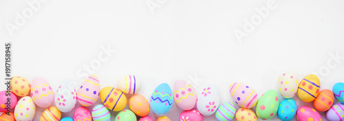 Colorful Easter Egg bottom border against a white banner background. Top view with copy space.