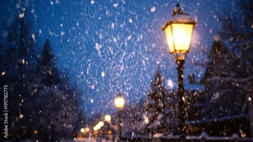 Snowfall in a serene winter landscape with illuminated street lamps.