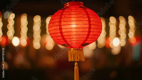 Red Chinese Lantern on a Stick with Blurred Background Lights.