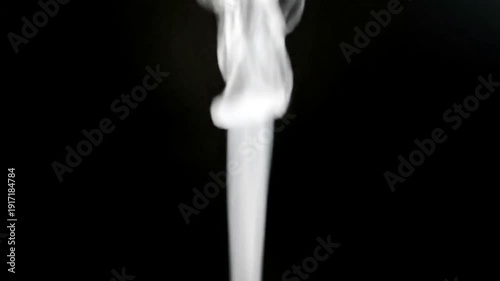 White smoke rising on a black background.