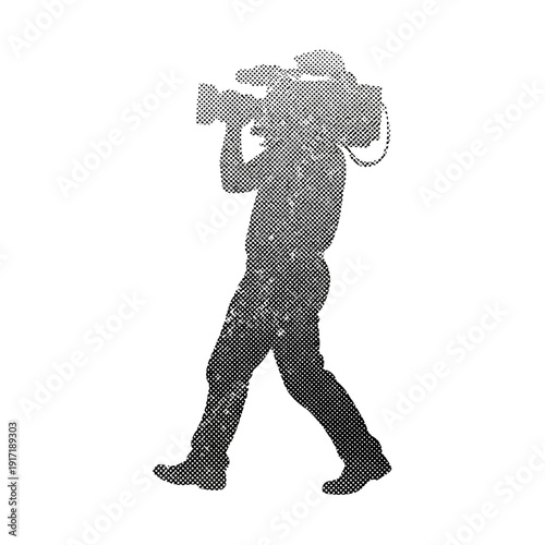 Silhouette of a cameraman walking with a video camera on his shoulder