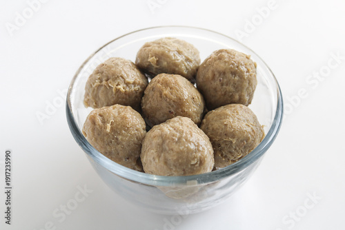 Photography A minimalist and clean presentation of Smooth Beef Meatballs (Bakso Sapi Halus) in a glass bowl