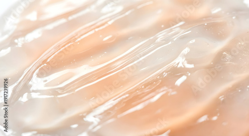Glossy cosmetic gel texture, macro swatch of peach skincare serum or moisturizer cream background.