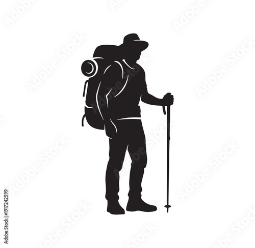 man wearing hat and backpack standing with trekking pole outdoors