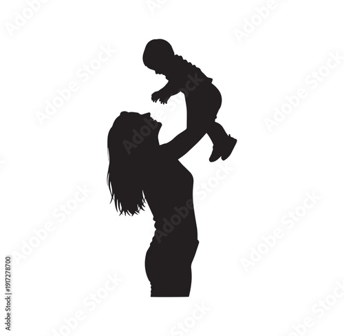 Silhouette of a woman lifting a baby up in the air  happy family moment