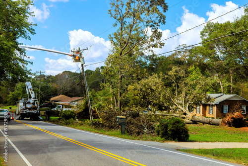 Bild auf Leinwand Cleanup efforts after tree falls on house in residential area