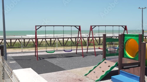 Colorful playground equipment sits on the beach in Navegantes, Brazil.