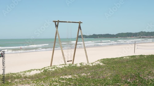 Wooden swing on a sandy beach in Navegantes, Brazil