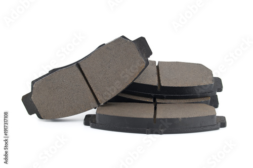Slika na platnu Stack of new car brake pads with grooves for heat dissipation on a white backgro