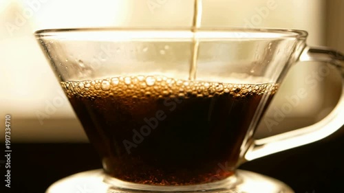 Multiple Pour Over Coffee Brewing in Clear Glass Cups on White Countertop with Warm Lighting