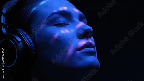 Woman Wearing Headphones in Dark Studio.