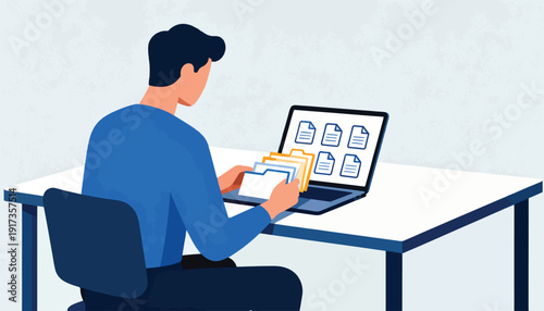 Man sorting digital files on laptop with physical folders beside it