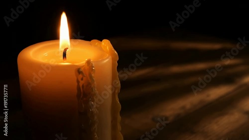 Multiple Lit Candles Creating Warm Ambiance in Darkened Room with Dramatic Lighting