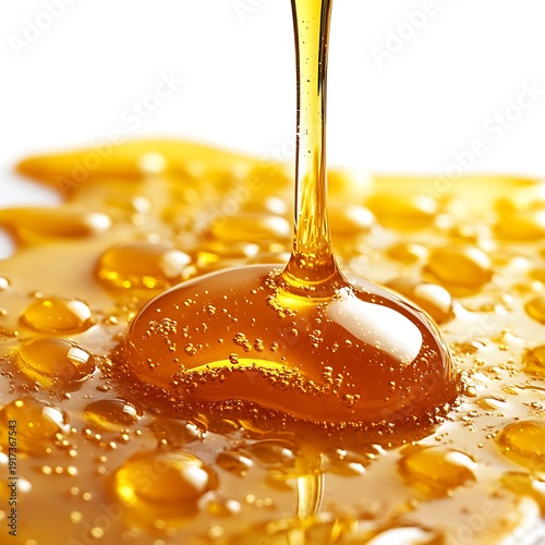 Thick Golden Honey Pouring and Spreading on Surface liquid amber photo