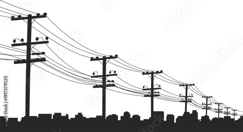 Silhouette of utility poles and power lines against a city skyline electricity cables
