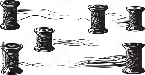 Black thread spools with trailing strings on white background