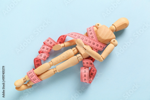 Wooden mannequin with pink ...