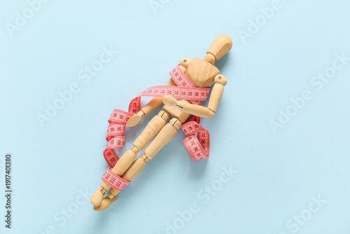 Wooden mannequin with pink ...