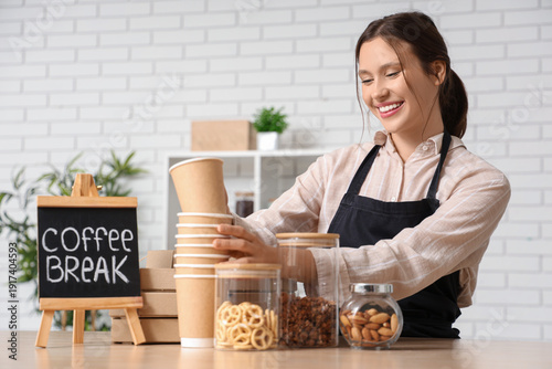 Happy young female barista ...