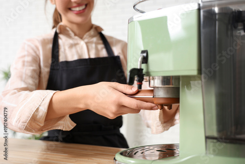 Happy young female barista ...