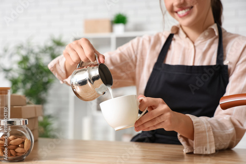 Happy young female barista ...
