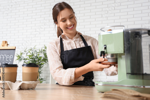 Happy young female barista ...
