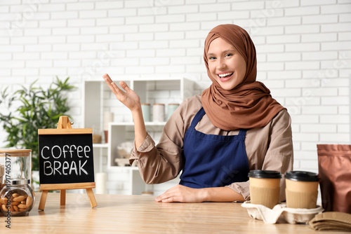 Happy young female barista ...