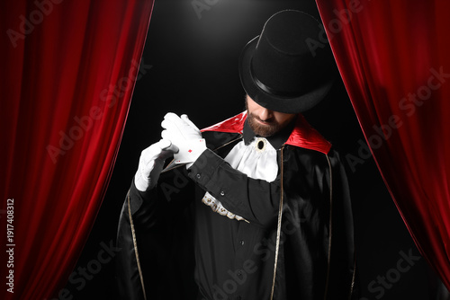 Male magician taking playin...