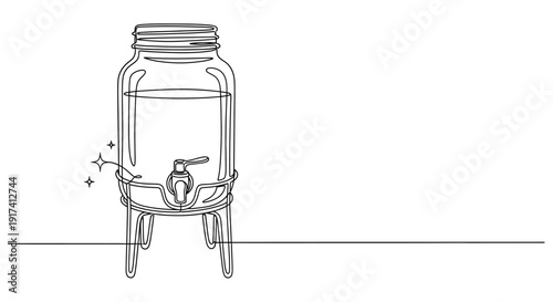 A clear glass beverage dispenser with a tap and lemons sits on a table indoors.