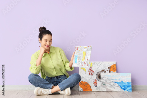 Young woman with paintings ...
