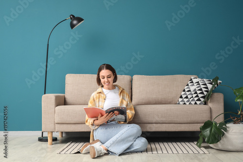 Young woman reading magazin...