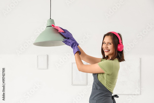 Female janitor in headphone...