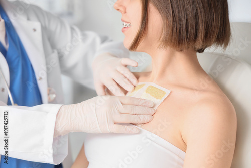 Female doctor applying must...