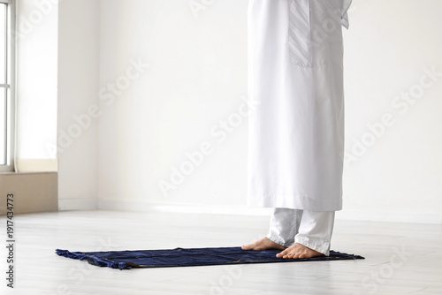 Muslim man praying on praye...