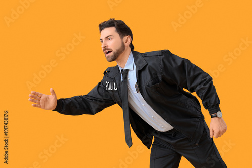 Male police officer with ba...