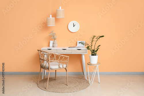 Clock on orange wall near w...