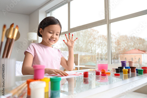 Cute Asian girl painting in...