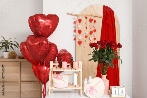 Interior of festive bathroom with heart-shaped balloons, roses and gift boxes. Valentine's Day celebration