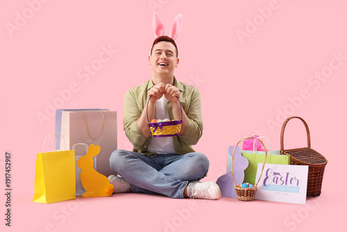 Young man in bunny ears wit...