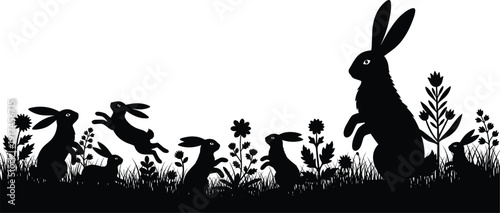 Silhouette of a rabbit standing tall in a field of plants and flowers at sunset