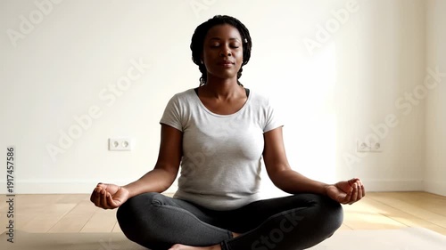 Wallpaper Mural A calm African American woman practices meditation in a peaceful setting, focusing on mindfulness and relaxation. Torontodigital.ca