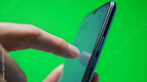 Wallpaper Mural A detailed shot of a hand using a mobile phone with a chroma key green screen, perfect for overlays. Torontodigital.ca