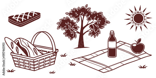 A picnic basket filled with bread and fruit under a tree with a bottle of wine and a blanket.