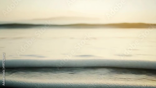 Textured sand ripples forming on the beach, gently meeting the incoming ocean waves under the soft glow of golden hour light, creating a serene and peaceful natural coastal landscape environment