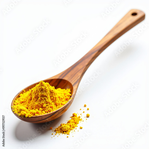 A wooden spoon filled with vibrant turmeric powder on a white background