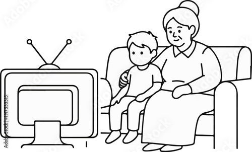 Grandmother and grandson sit on couch watching television