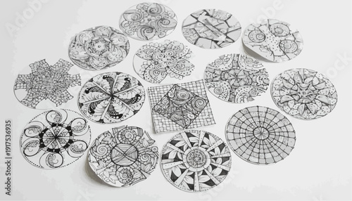 Intricate black and white circular patterns on paper. The artistic compositions show diversity of mandala art, which are arranged beautifully