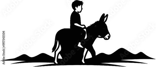 Silhouette of a boy riding a donkey through hilly terrain