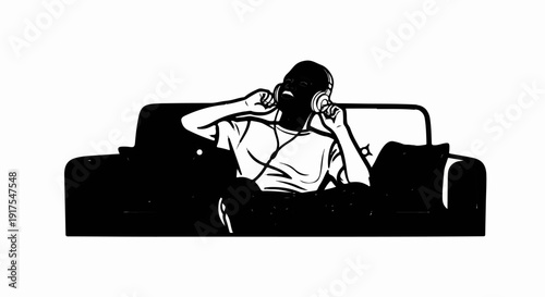 Person wearing headphones and enjoying music while seated on a sofa