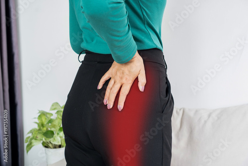Woman suffering from sciatica or hip pain with red highlight on leg. Concept of nerve pain, muscle injury, joint inflammation